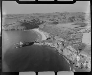 Phonolite Cobble Beach and headland with railway line in foreground, with Purakaunui Bay with Purakaunui Inlet beyond, Waitati, Otago Region