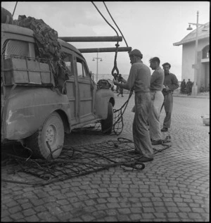 Staff car taken out of its slings after coming ashore at Bari, Italy, World War II - Photograph taken by George Kaye
