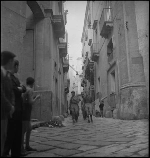 New Zealand soldiers explore the alleys of the port of Taranto, Italy, in World War II - Photograph taken by George Kaye