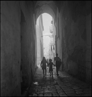 View of narrow streets through arch in Taranto, Italy, World War II - Photograph taken by George Kaye
