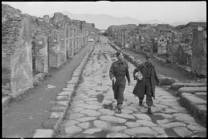Two New Zealand soldiers walk down ancient streets of Pompei, Italy, World War II - Photograph taken by George Kaye