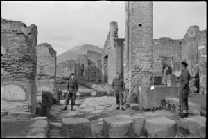 Three Kiwis stand at the intersection of the Stabian Way in Pompei, Italy, World War II - Photograph taken by George Kaye