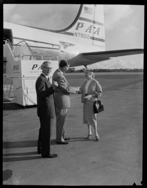 Unidentified Pan American World Airways model and two men in front of PAA N79012 aeroplane, Whenuapai Airport, Waitakere, Auckland city