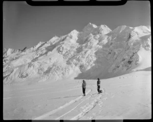 Mount Cook Air Services Auster ZK-BLZ Ski Plane and two unidentified women at the head of the Tasman Glacier with Mount Tasman beyond, Mount Cook National Park, Canterbury Region