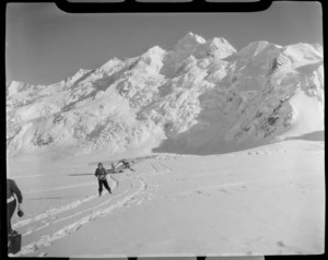 Mount Cook Air Services Auster ZK-BLZ Ski Plane and an unidentified women at the head of the Tasman Glacier with Mount Tasman beyond, Mount Cook National Park, Canterbury Region