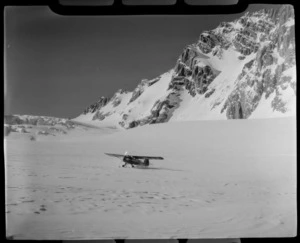 Mount Cook Air Services Auster ZK-BLZ Ski Plane landing at the head of the Tasman Glacier with snow covered mountains beyond, Mount Cook National Park, Canterbury Region