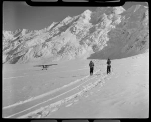 Mount Cook Air Services Auster ZK-BLZ Ski Plane and two unidentified women at the head of the Tasman Glacier with Mount Tasman beyond, Mount Cook National Park, Canterbury Region