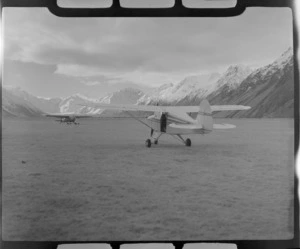 Mount Cook Air Services Piper Tripacer and Auster Ski Planes on the Hermitage Airfield with snow covered mountains beyond, Mount Cook National Park, Canterbury Region