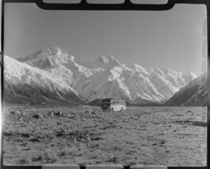 Mount Cook and Southern Lakes Tourist Coach on the Hermitage Road, Mount Cook Village, with Mount Sefton beyond, Mount Cook National Park, Canterbury Region