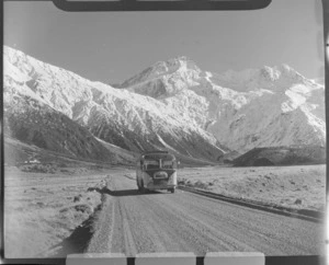 Mount Cook and Southern Lakes Tourist Coach on the Hermitage Road, Mount Cook Village, with Mount Sefton beyond, Mount Cook National Park, Canterbury Region