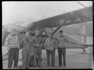 Sir Edmund Hillary and four men in front of Antarctic Beaver NZ6001 Ski Plane, Mount Cook Airfield, Mount Cook National Park, Canterbury Region