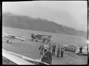 Mount Cook Airfield with Mount Cook Air Services Auster ZK-BLZ and Piper Tripacer Ski Planes and Sir Edmund Hillary's Antarctic Beaver NZ6001 Ski Plane with unidentified men, Mount Cook National Park, Canterbury Region