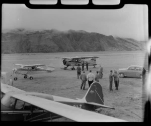 Sir Edmund Hillary's Antarctic Beaver and Mount Cook Air Services Ski Planes at Mount Cook Airfield with unidentified people looking on, Mount Cook National Park, Canterbury Region