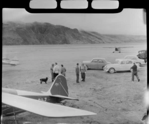 Sir Edmund Hillary's Antarctic Beaver Ski Plane taking off at Mount Cook Airfield with six unidentified people looking on, Mount Cook National Park, Canterbury Region
