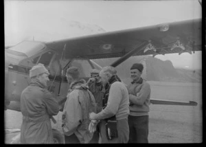 Five men in front of Sir Edmund Hillary's Antarctic Beaver NZ6001 Ski Plane, Mount Cook Airfield, Mount Cook National Park, Canterbury Region