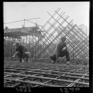 Two unidentified men, laying reinforcing steel at a building site [for a new government building?], Bowen Street, Wellington