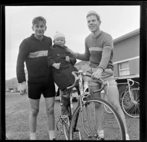 Two unidentified cyclists with young boy balanced on bike, Petone, Lower Hutt