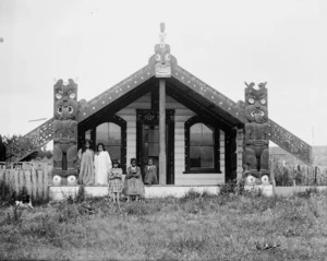 Unidentified group of Maori girls standing alongside Kikopiri meeting house in the Horowhenua