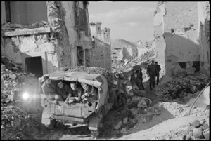 NZ truck negotiating rubble in main street of the village of Mignano in Italy during World War II - Photograph taken by George Kaye