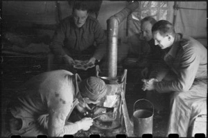Staff of NZ Reinforcement Unit installing a stove inside their tent, Italian 5th Army Front, World War II - Photograph taken by George Bull