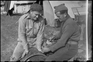 Gunner C S Land (Auckland) and Corporal G M Winlove making drum oven at their camp in Italy, World War II - Photograph taken by George Bull