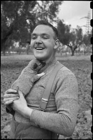 Private E R Hiscoke and puppy mascot Ace at the NZ Reinforcement Transit Unit, Italy, World War II - Photograph taken by George Bull