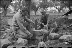 Gunner C S Land (Auckland) and Corporal G M Winlove laying foundation for their field oven, Italy, World War II - Photograph taken by George Bull