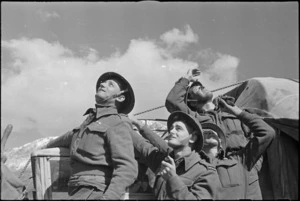 NZ anti aircraft gunners watch bombers flying over to participate in air assault on Cassino, Italy, World War II - Photograph taken by George Kaye