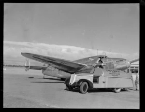 Lockheed Lodestar aeroplane 'Karoro' ZK-AHU, being refuelled by unidentified aircraft technicians, an an aerodrome, location unidentified