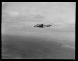 A Lockheed Model 18 Lodestar aeroplane, flying over an unidentified location