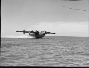 A Consolidated Coronado flying boat, skimming over the sea, location unidentified