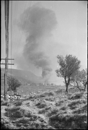 Smoke from large ammunition dump burning behind the lines in NZ Sector of 5th Army Front in Italy, World War II - Photograph taken by George Kaye