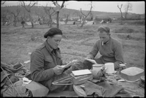A Neill and G McIndoe, NZ Infantry, read letters behind the lines on the Cassino Front, Italy, World War II - Photograph taken by George Kaye