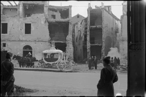 Elaborate hearse in front of damaged building in Italian town in the Volturno Valley, World War II - Photograph taken by George Kaye