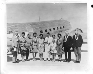 Group of unidentified people, including European and Pacific Islanders [Cook Islanders?] in front of a NZ3519 C47 transport plane, Aitutaki airport, Cook Islands