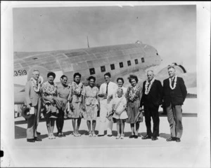 Group of unidentified people, including European and Pacific Islanders [Cook Islanders?] in front of a NZ3519 C47 transport aircraft, Aitutaki airport, Cook Islands