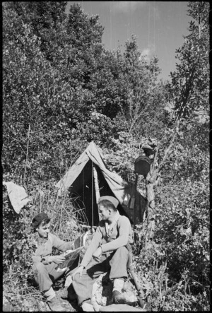 M Shrimpton and W Thessman in front of their bivvy in bush similar to New Zealand, Italy, World War II - Photograph taken by George Kaye