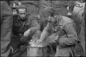 New Zealander C W Benson watches American C W Mann spot welding on 5th Army Front, Italy, World War II - Photograph taken by George Kaye
