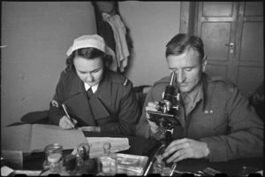Nurse Judy Robertson and Major M R Fitchett at work in the laboratory of 2 NZ General Hospital, Caserta, Italy, World War II - Photograph taken by George Bull