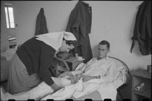Sister E A Worsp bandaging Private J Donnelly at 2 NZ General Hospital, Caserta, Italy, World War II - Photograph taken by George Bull