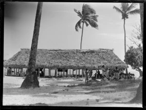 View of a large beach fale tele thatch roof native hut used as a [School?] with lessons underway, Apia, Western Samoa