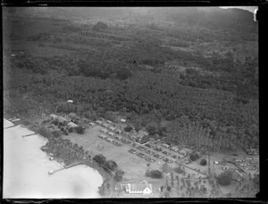 Aerial view of a coastal village with a church and neatly arranged rectangular modern [native?] housing, Apia, Western Samoa