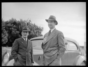 Portrait of (L to R) F Maurice of Union Airways and D Hood of BOAC outdoors in front of a car at Rongotai Airport, Wellington