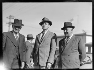 Portrait of (L to R) E Hewett, D G Sisson and A Playle of the Oceanic Steamship Company in front of cars, location unknown