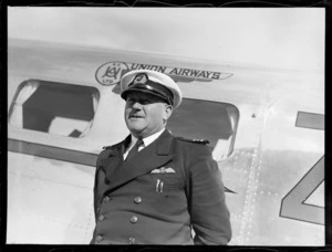 Portrait of Captain A T Orchard of Union Airways in front of a Union Airways plane, Rongotai Airport, Wellington