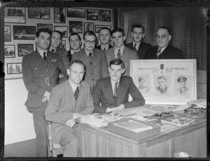 Group portrait, Air Force Association members with a wall plaque of 'New Zealand's VC's of the Air, 1914-18 and 1939-45' within Whites Aviation Offices, Auckland