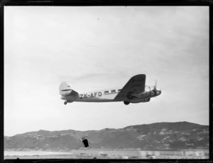 Lockheed Electra ZK-AFD aircraft, side view in flight, Rongotai airport, Wellington