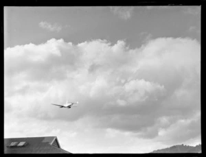 Lockheed Electra aircraft, over Rongotai airport, Wellington with clouds in background