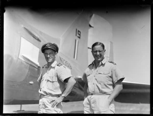 Portrait of Second Lieutenant C W Franks on right, and Flight Lieutenant N S Irvine in front of a Dakota transport plane, Tontouta Airfield, New Caledonia
