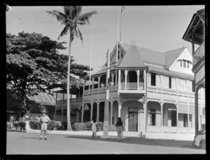 The three story wooden Casino Hotel with locals walking by, Apia, Western Samoa